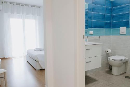 a bathroom with a bed and a toilet and a sink at BnB Nuova Vita in Paola