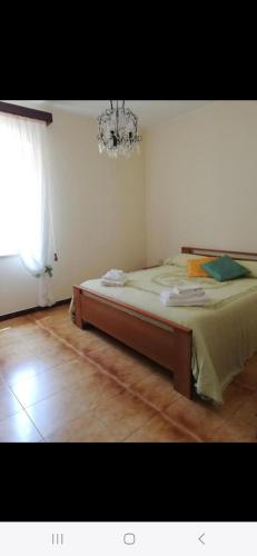 a bedroom with a bed and a chandelier at Adelegigi in Cetara