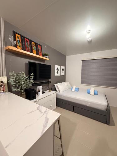a bedroom with a bed and a large window at Near Mactan Airport, Pool, Fast WiFi, Netflix & Disney in Lapu Lapu City