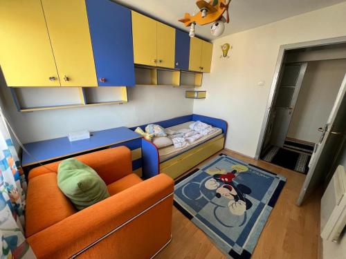 a small childs room with a bed and a couch at Sheshi-Prizren in Prizren