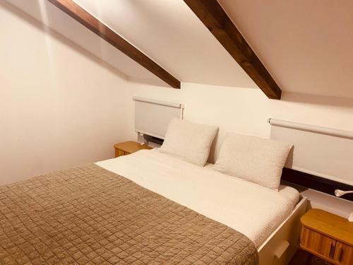a bedroom with a bed with two pillows at Lemba, apartman 4 zvjezdice in Opuzen