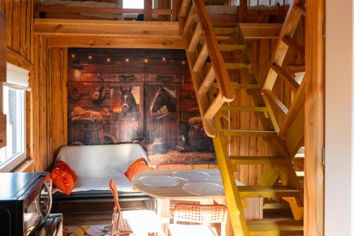 a wooden staircase in a room with a wall at Лісова Хатка in Parowa