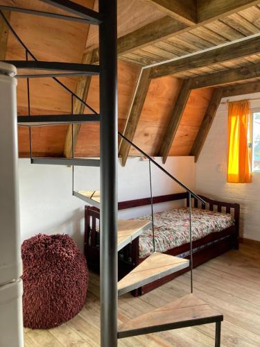 a bedroom with a bunk bed and a staircase at Don Cleto "La Mimosa" in Aiguá