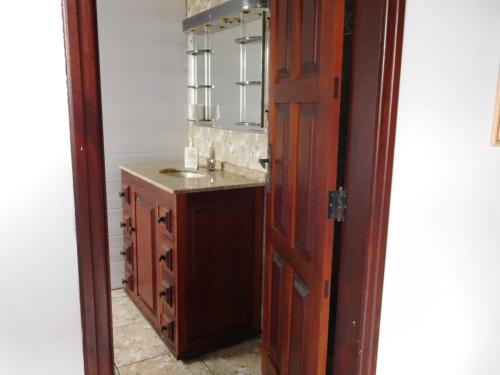 a bathroom with a sink and a mirror at Vibe Hostel Paraty in Paraty