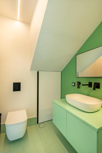 a bathroom with a sink and a toilet at Black Mountain Villas in Kefallonia