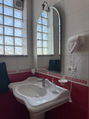 a bathroom with a sink and a mirror at Valentino Apartments in Shkodër
