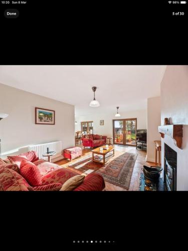 a living room with a couch and a fireplace at Beautiful views spacious 4 bed detached in Alvanley