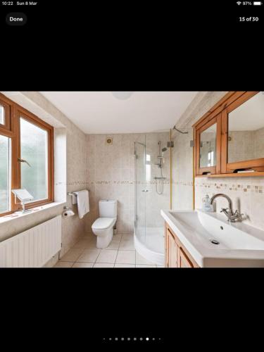 a bathroom with a sink and a toilet and a shower at Beautiful views spacious 4 bed detached in Alvanley