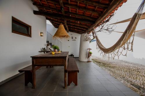 a room with a wooden table and a ceiling at Casa da Ponte de Mucela in Vila Nova de Poiares