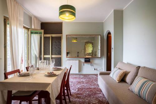 a living room with a table and a couch at ApartVilla Trieste in Trieste