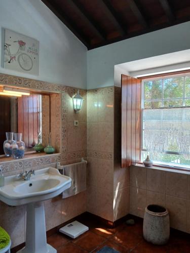 a bathroom with a sink and a window at Casa da VíVí in Azenha de Baixo
