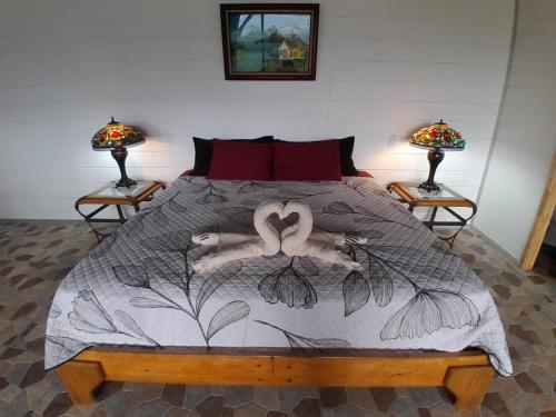 a bedroom with a bed with two lamps on two tables at RIGE s Home in Palma