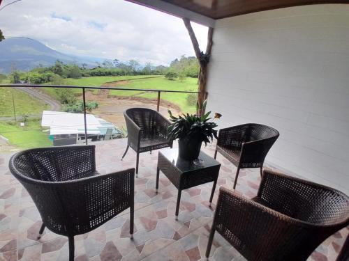 a porch with chairs and a table with a vase on it at RIGE s Home in Palma