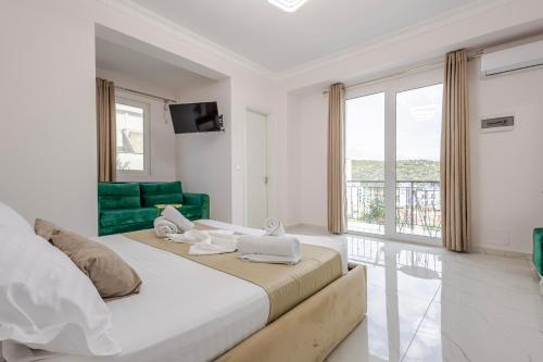 a bedroom with two beds and a large window at Golden Hill Ksamil in Ksamil