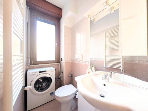 a bathroom with a washing machine and a sink at Popi House in Menaggio