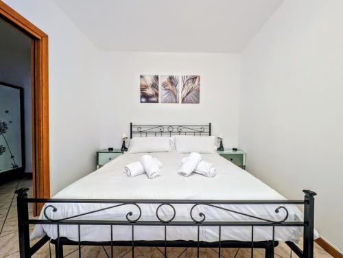 a bedroom with a bed with two white pillows at Popi House in Menaggio