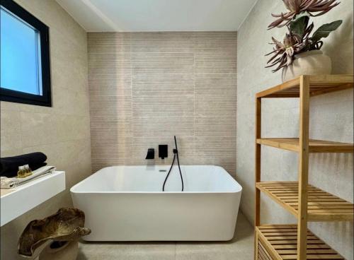 a bathroom with a white tub in a room at villa sam in Feyzin