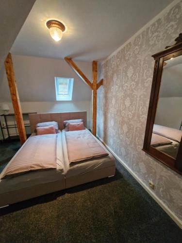 a bedroom with a bed and a mirror at Apartmány Saxana in Smržovka