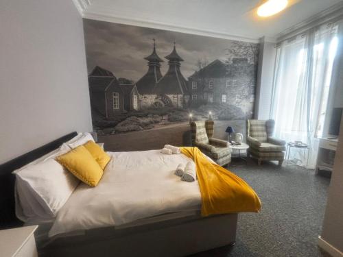 a bedroom with a bed and a painting on the wall at Ugie House in Keith