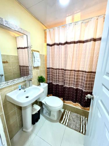 a bathroom with a toilet and a sink at Moderno Apartment Near the Ocean Santo Domingo Este Wife ,AC in La Francia