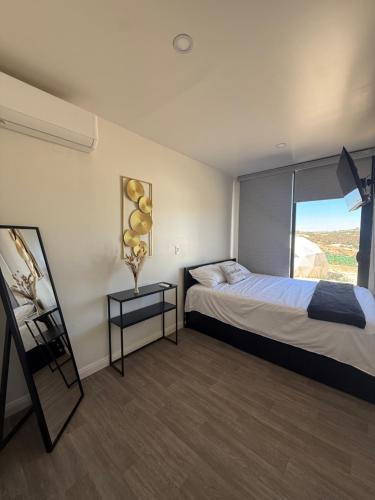 a hotel room with a bed and a window at Cabañas aldebaran cienega redonda in Hechicera