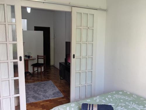 a bedroom with a door leading into a room at Acomodaçao Ipanema in Rio de Janeiro
