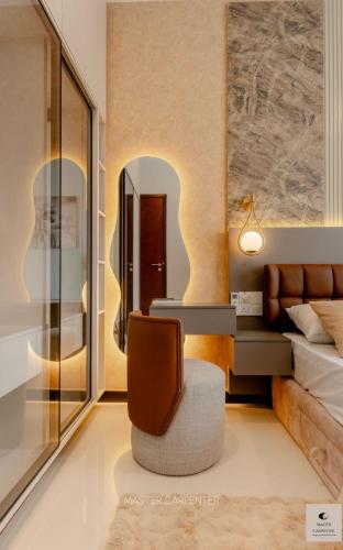 a bedroom with a bed and a desk and a chair at Luxury Trizen Aki Apartments in Colombo