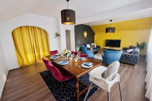 a living room with a dining table and chairs at Shalhome 1 Comfort at the gates of Strasbourg in Lingolsheim