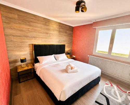 a bedroom with a bed with a teddy bear on it at Shalhome 1 Comfort at the gates of Strasbourg in Lingolsheim