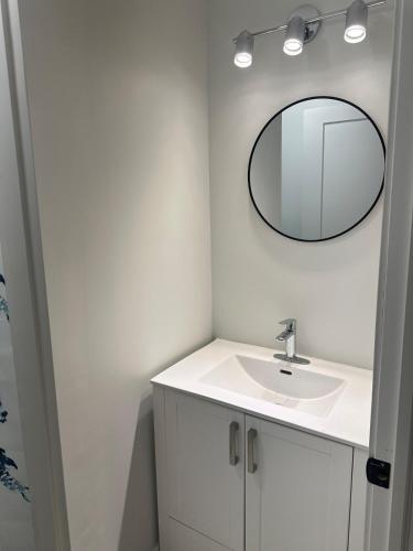 a bathroom with a sink and a mirror on the wall at Bournas Nest in Hammonds Plains