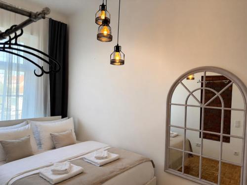 a bedroom with a bed with a mirror and lights at Urban by BestChoice - FREE Parking - Self Check-in in Graz