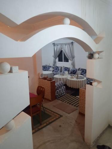 a room with a dining room with a table at Maison du Bonheur berbère in Aït Ougliff