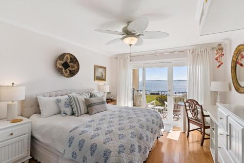 a bedroom with a bed and a balcony with the ocean at Pier Pointe #101 - 100 Floyd Street, Unit 101 in Saint Simons Island