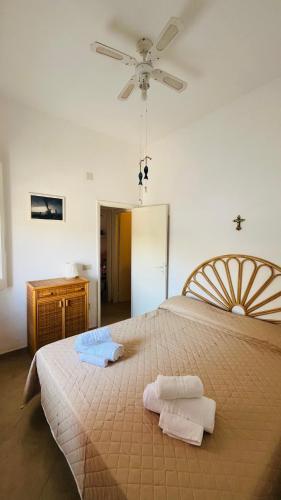 a bedroom with a large bed with two towels on it at Mare Infinito in Pantelleria