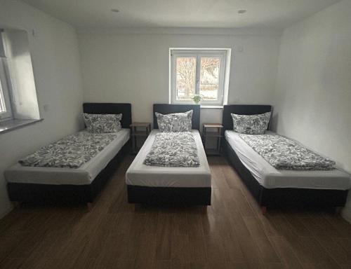 a room with two beds and a window at Casita 2 in Essenbach