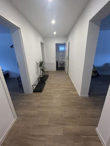 an empty hallway with white walls and tile floors at Casita 2 in Essenbach