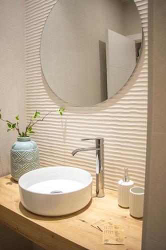 a bathroom with a white sink and a mirror at Jerez Centro Alojamiento Boutique in Jerez de los Caballeros