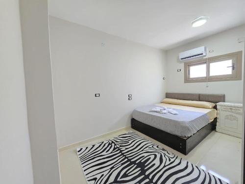 a small room with a zebra print rug in it at casabianca north coast villa code 112 in Dawwār Muḩammad Abū Shanab