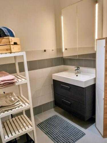 a small bathroom with a sink and a shelf at Resta Con Me in Genoa