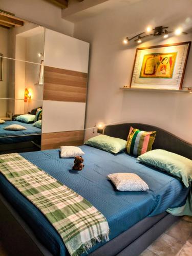 a bedroom with two beds and a teddy bear sitting on the bed at Resta Con Me in Genoa