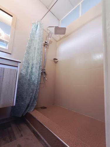 a shower in a bathroom with a shower curtain at Sam & Chlo Studio & Appartment - Grand Baie - Mauritius in Grand-Baie