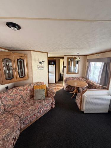 a rv living room with a couch and a table at Holiday Home Arbroath in Arbroath