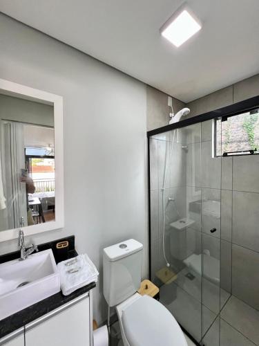 a bathroom with a toilet and a sink and a shower at Studio Garten Container in Joinville
