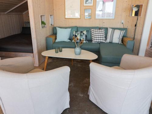 a living room with a couch and two chairs at 4 star holiday home in Hadsund in Hadsund