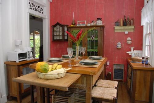 a kitchen with a table with a bowl of fruit on it at House On The Path in Windward Side