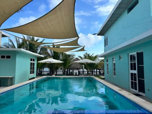 a swimming pool with a roof over it at La casa de Fercho in Sipacate
