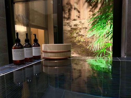 three bottles of wine sitting on a glass counter at TSUDOYA Tennoji 集家天王寺 in Osaka