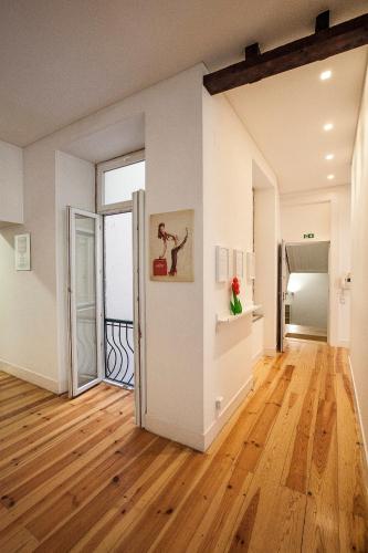 a living room with a wooden floor and an open door at Pop Art Lisboa 204 in Lisbon