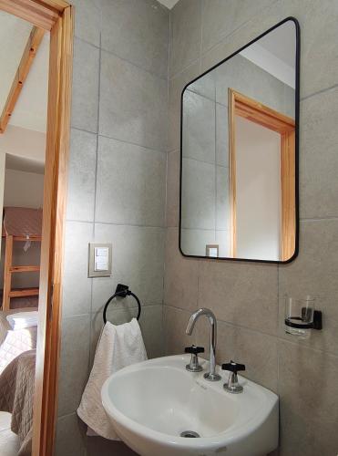 a bathroom with a sink and a mirror at Dormis H35 in Ataliva Roca