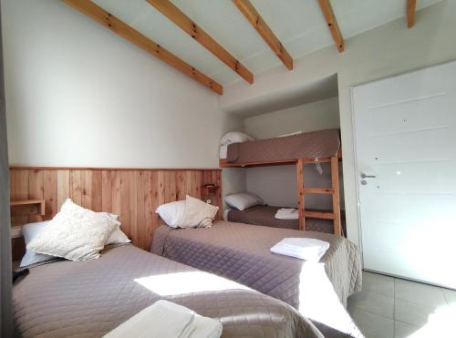 a bedroom with two beds and a bunk bed at Dormis H35 in Ataliva Roca